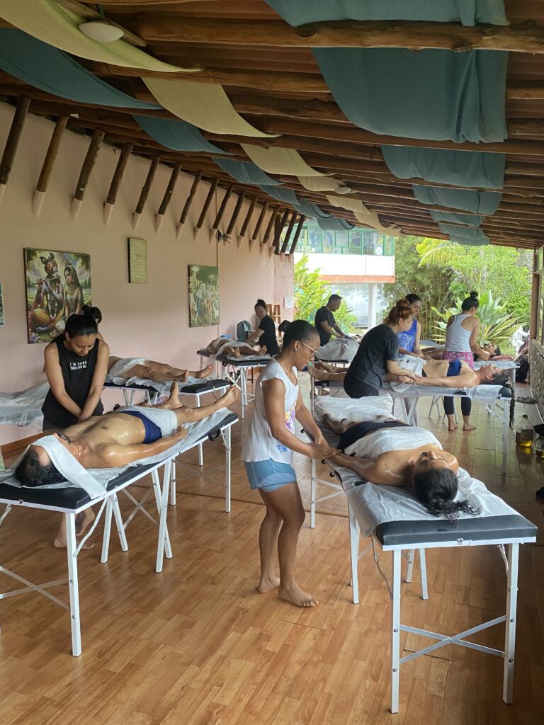 Students practicing Abhyanga massage in the Cali Ayurveda shala