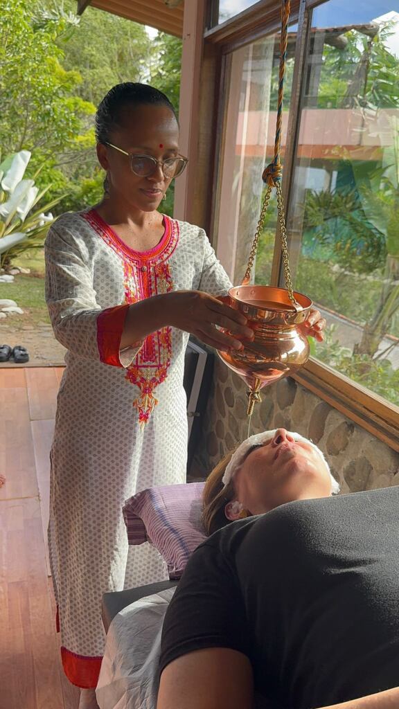 Guided Shirodhara practice during Ayurveda training in Cali