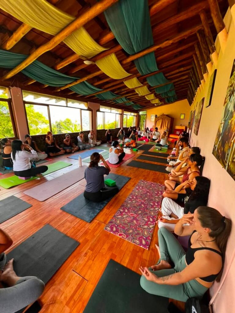 Students seated together in the Cali yoga shala